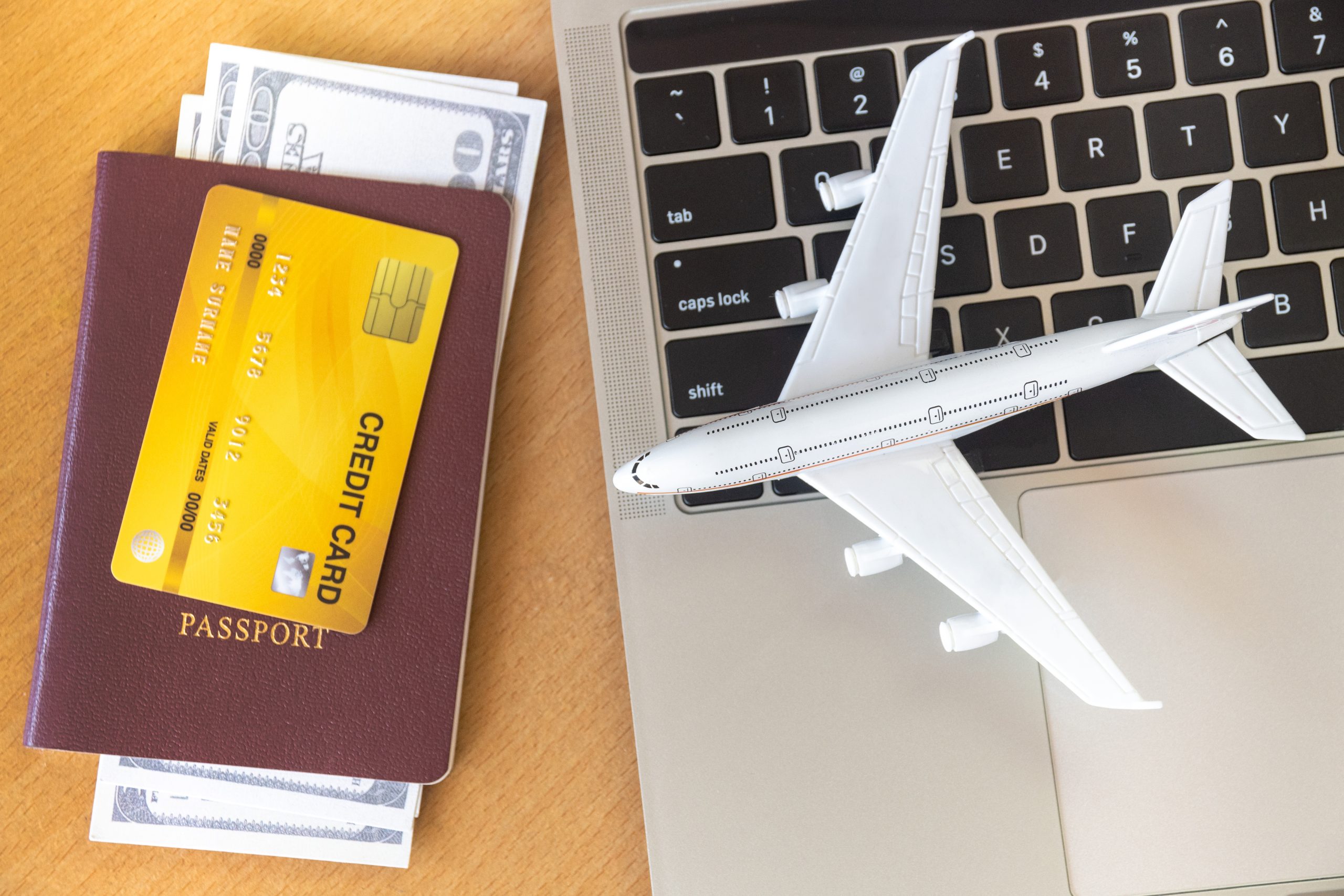 Air tickets, passports and credit card near laptop computer and